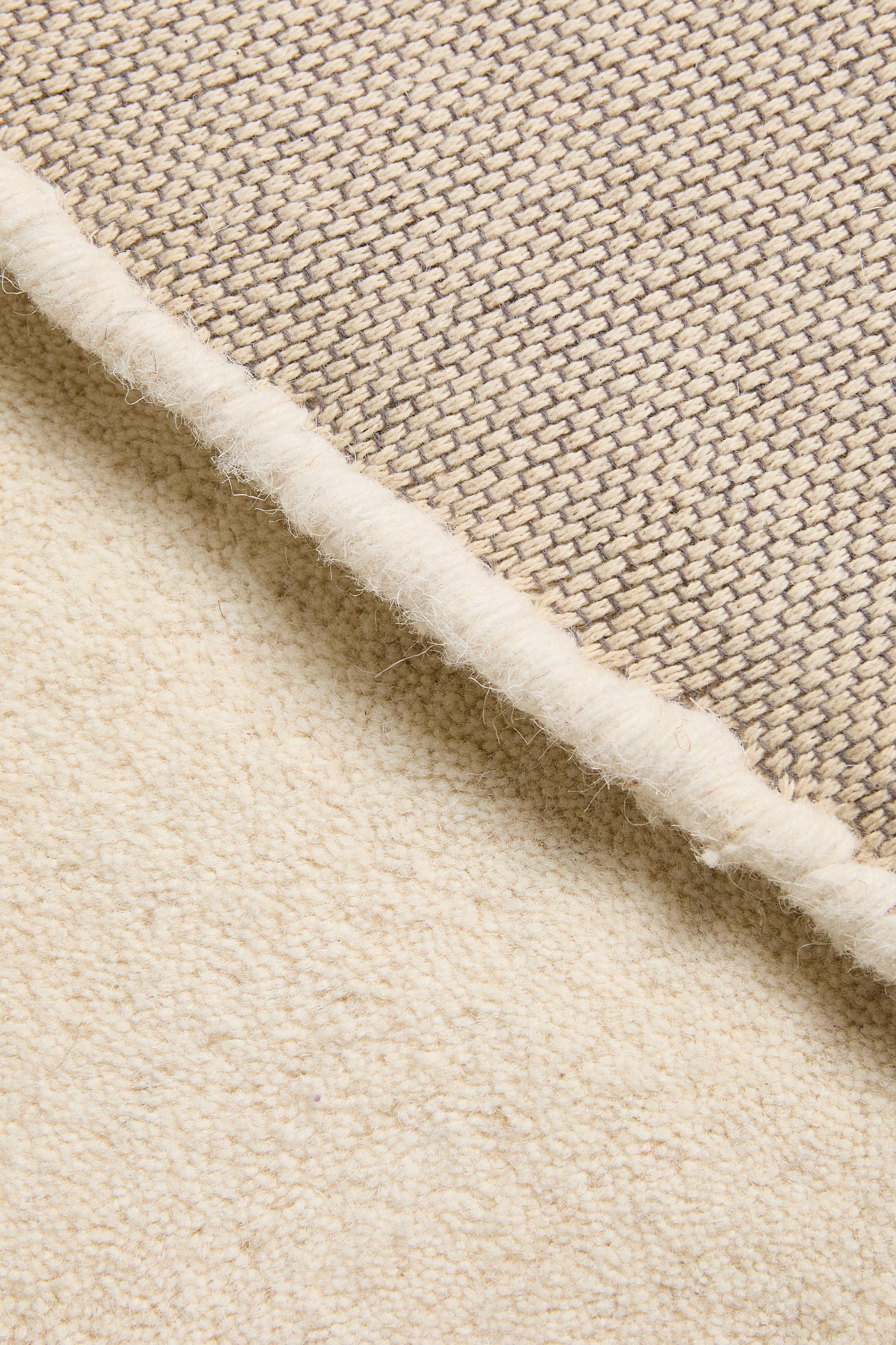 PLAIN IRREGULAR WOOL AREA RUG